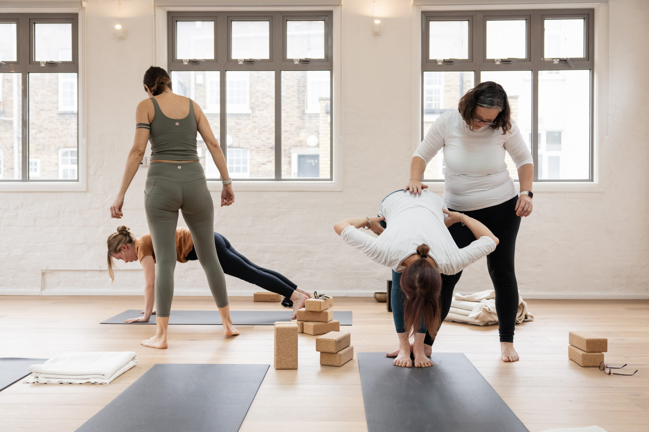 Students learning together during part-time yoga teacher training in London while working full-time